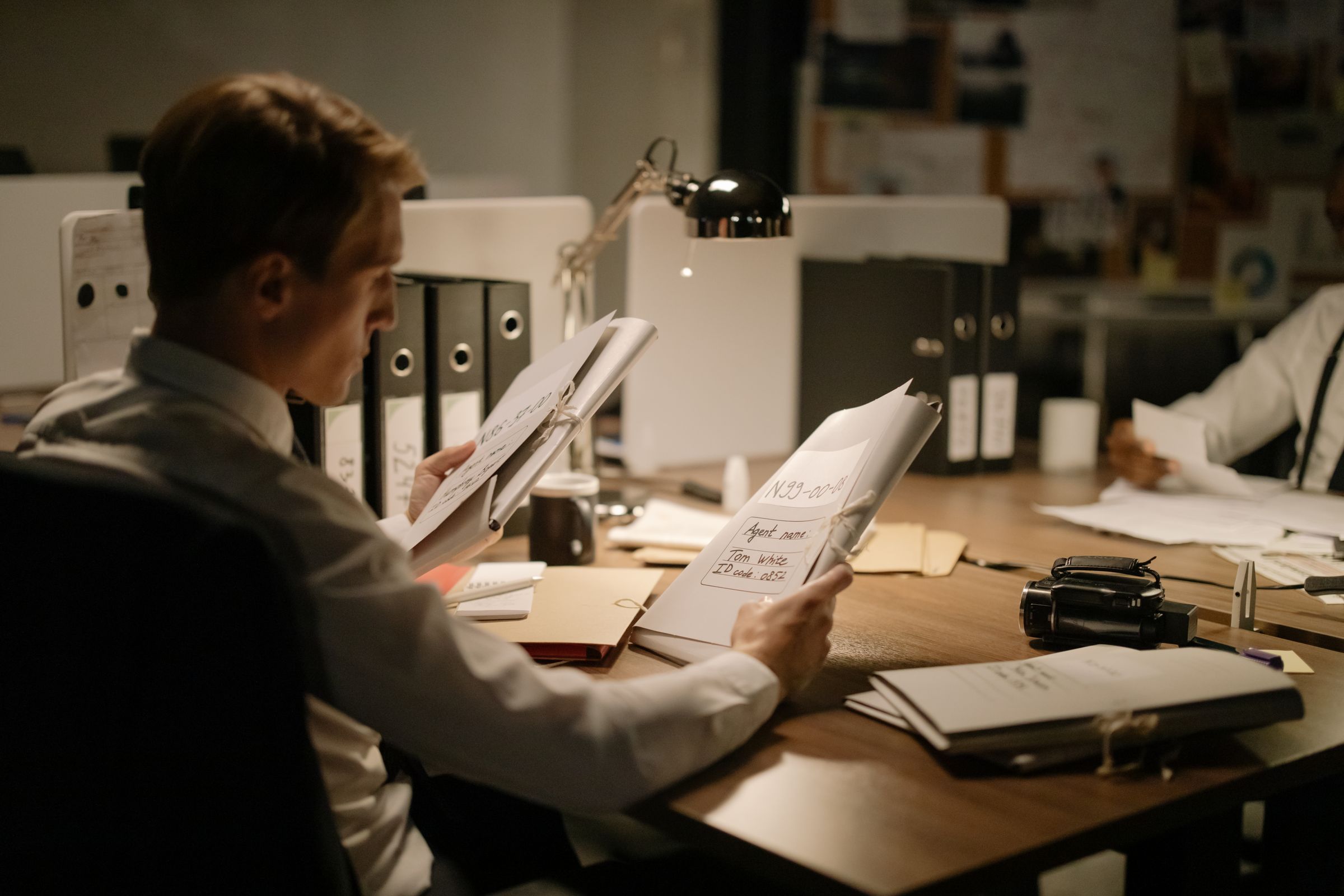 Investigators reviewing case files and evidence in an office