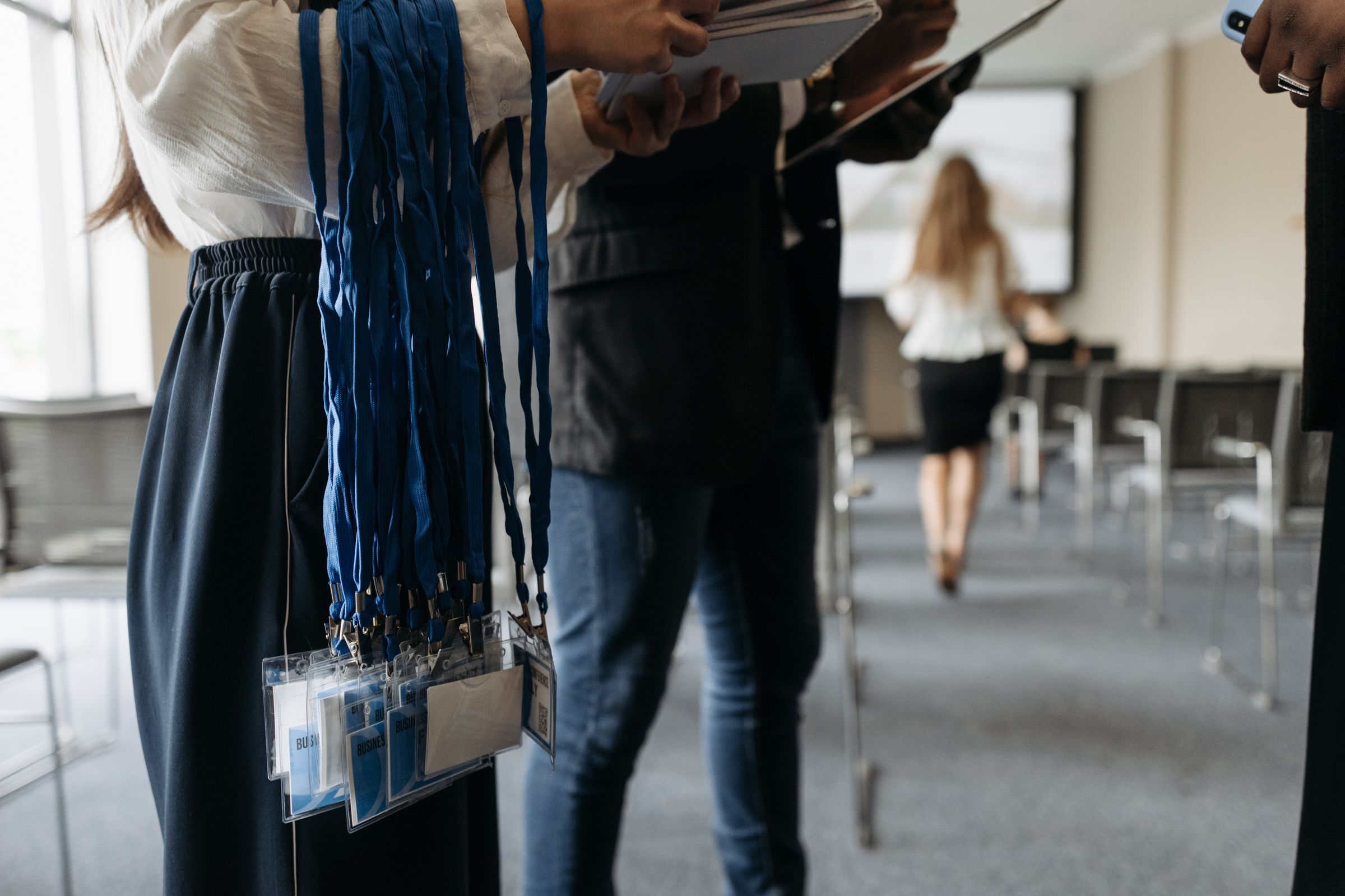 Event accreditation staff preparing guest badges and lanyards